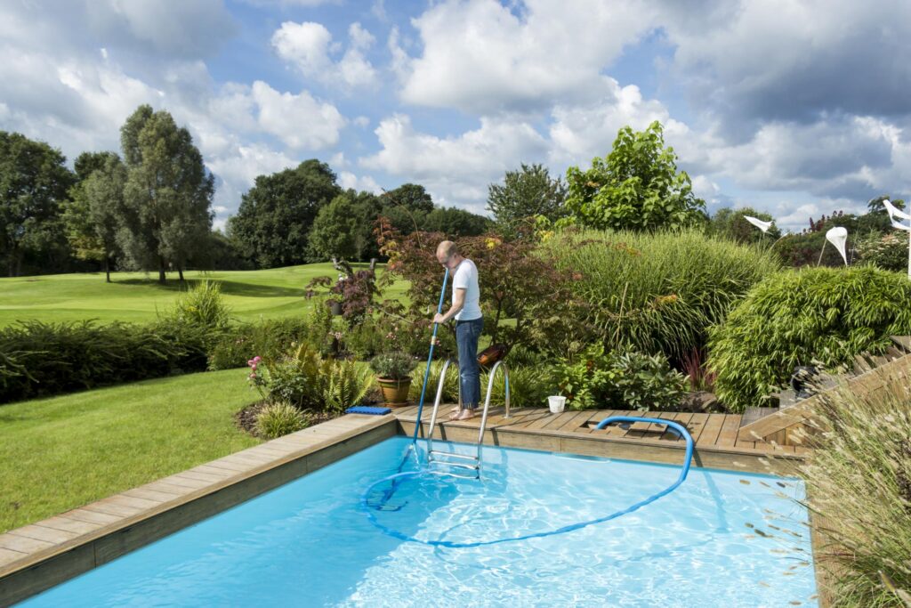 man cleaning the pool